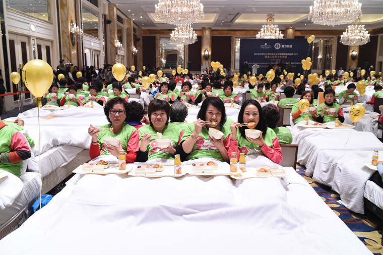 The most people eating breakfast in bed is 388 and was achieved by Pudong Shangri-La, East Shanghai (China) in Shanghai, China in celebration of Guinness World Records Day 2014. 

Online Press Office URL: http://onlinepressoffice.tnrcommunications.co.uk/ tallest-and-shortest-man  
Password:  records                
Site live from:  1700 GMT, Wednesday 12th November 2014
Media Materials available: 0800 GMT, Thursday 13th November 2014
You will be required to enter your name, the name of your organisation, a valid email address and the above password to gain access to the site. Please note that the password is case sensitive.  
All visitors must accept the Terms &amp; Conditions of use governing the site before entering.
Any problems, please contact TNR on  (0)20 7963 7163